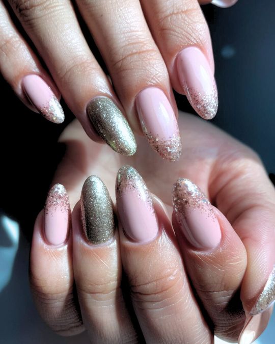 shellac manicures on almond shaped nails with glitter and pink tones