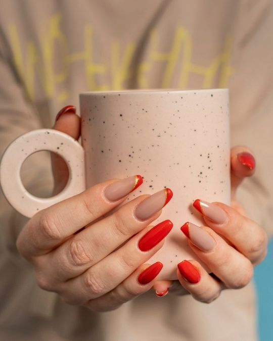 shellac manicures with red tones on coffin nails
