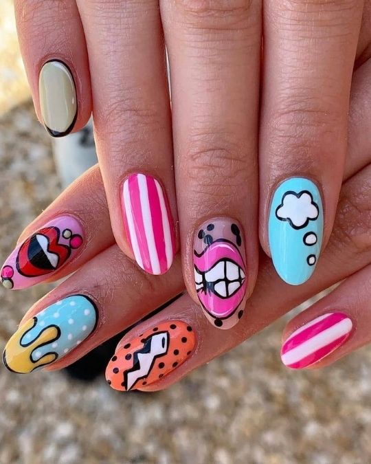 Almond nails with retro pop art designs, stripes, and cartoon elements.