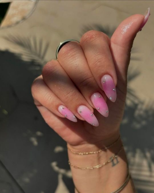 Tiny rhinestones on pink to white aura almond nails