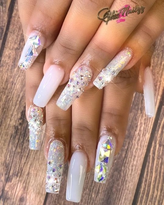 iridescent crystals and glitter on milky base long coffin nails
