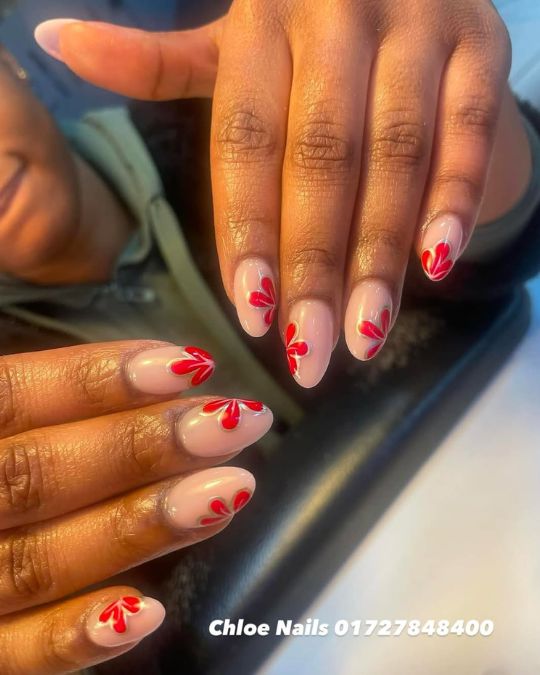 soft nude almond-shaped nails with red petals