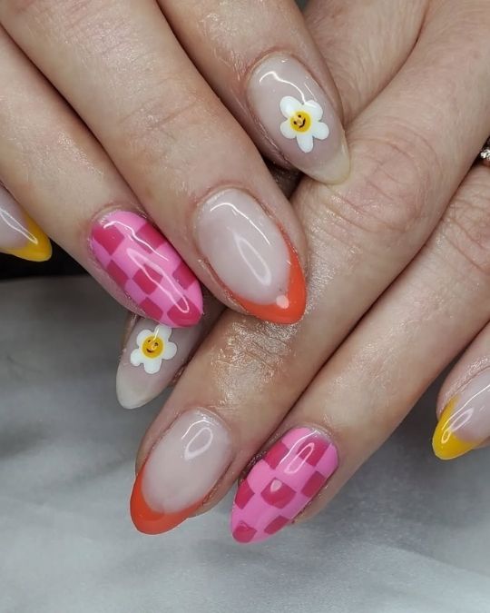 Smiley daisies, bold pink checkerboard, and colorful tips on short round nails