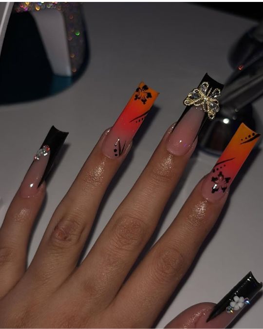 long square nails black and orange french tips with butterfly jewel