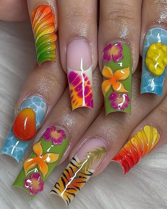 long square nails with tropical icons featuring rainbow, flowers, fruits, and tiger stripes