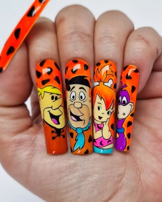 orange nails featuring Flintstones characters with leopard print background design.