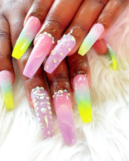Long coffin nails with pastel ombré design and crystal embellishments.