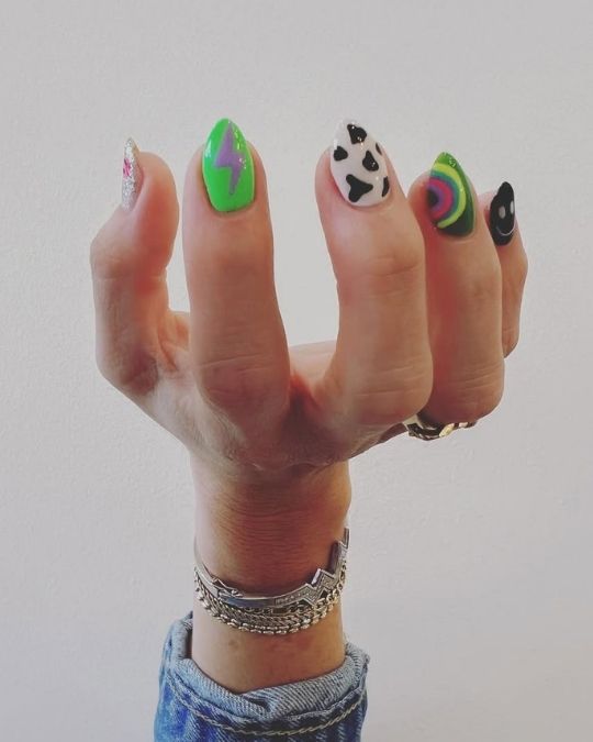 electric green with a purple flash to playful cow print and mesmerizing rainbow swirls nails