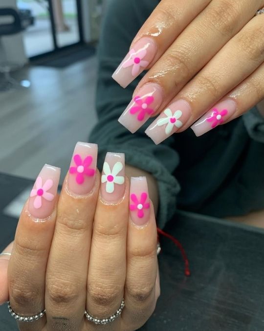 flower designs in vibrant hot pink and soft white square nails