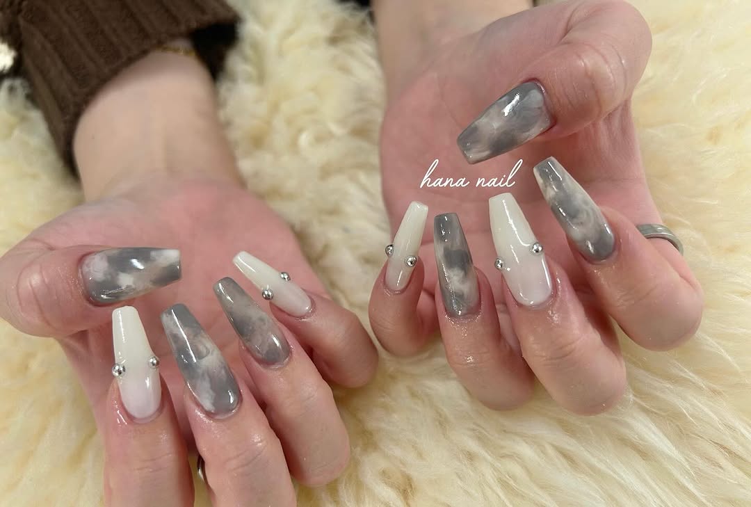 Long coffin nails alternate between gray marble effect and milky white nails