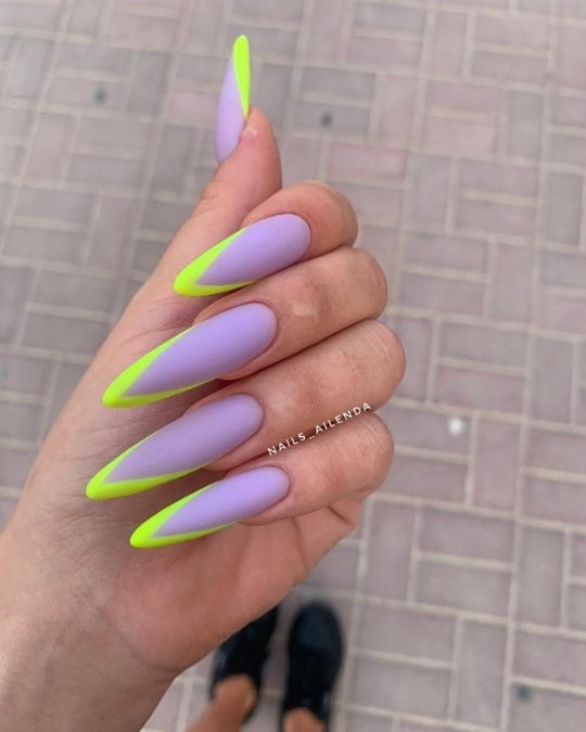 matte lavender base with neon green tips on stiletto nails