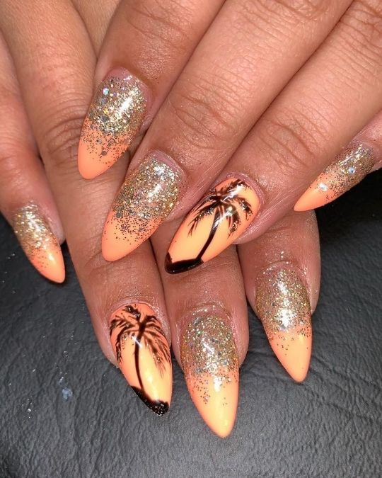 almond nails with bright orange as sunrise with black palm tree design