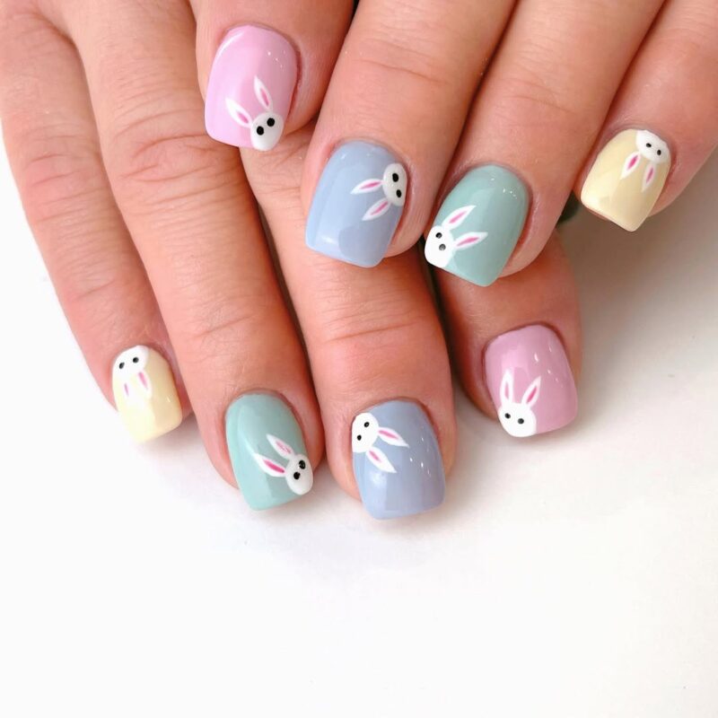 tiny bunnies saying hi on pastel color nails