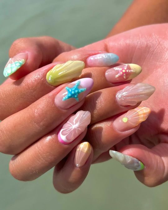 beach inspired almond nails with pastel hues, starfish designs, and pearlescent finishes