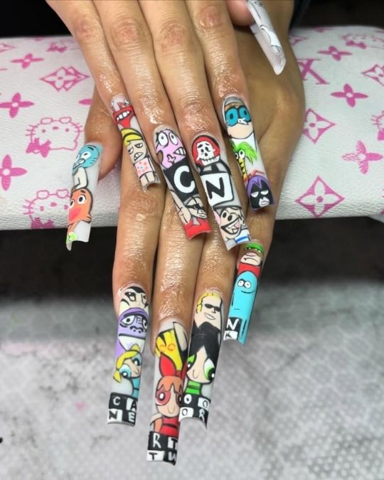 Long acrylic nails featuring Cartoon Network character artwork and network logos.