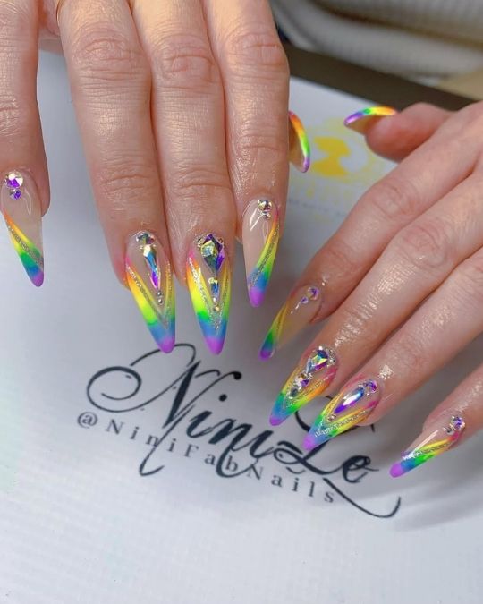 vibrant rainbow tips, shimmering crystals, and ethereal iridescence almond nails