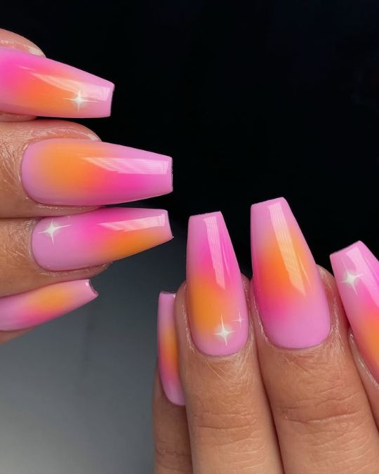 Pink and orange perfectly blend together featuring a summer sunset on long coffin nails