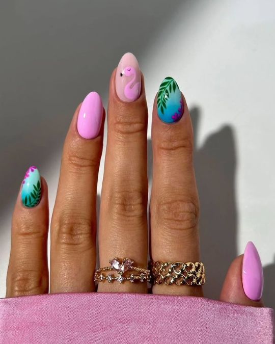 hand drawing pink flamingo and turquoise palm on almond nails