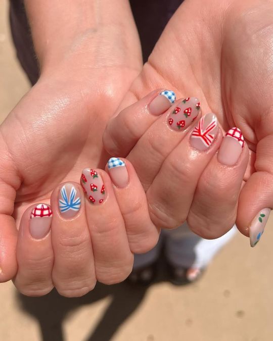 4th of july inspired short round nails with mix of red, white, and blue patterns