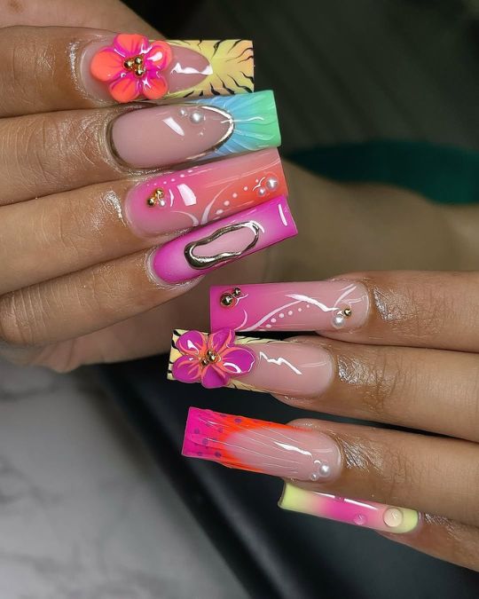 Long square nails with 3D flowers pop against vibrant color french tips