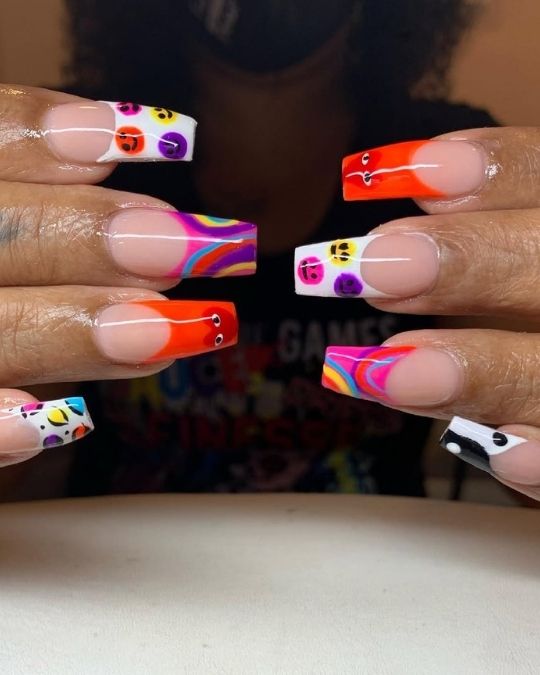 Vibrant French tips featuring smiley faces, swirls, and colorful abstract designs.