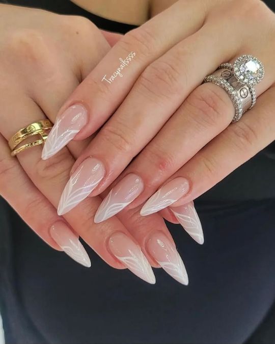 long stiletto nails with ethereal swirl ombre milky white colors
