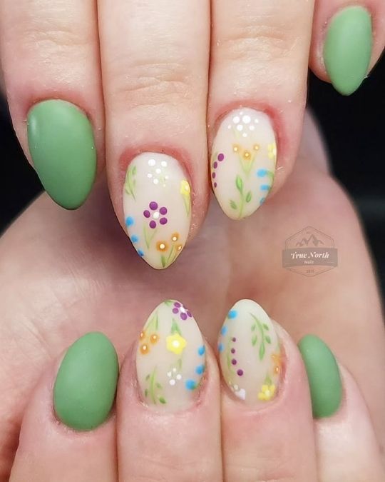 short stiletto nails with wildflowers on sheer base with green nail polish